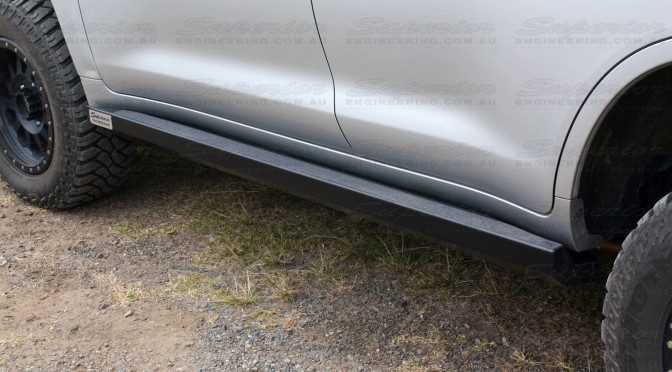 Close up view of a Superior Engineering Stealth Rock Slider fitted to a Toyota Landcruiser 200 Series - Rear closest to camera