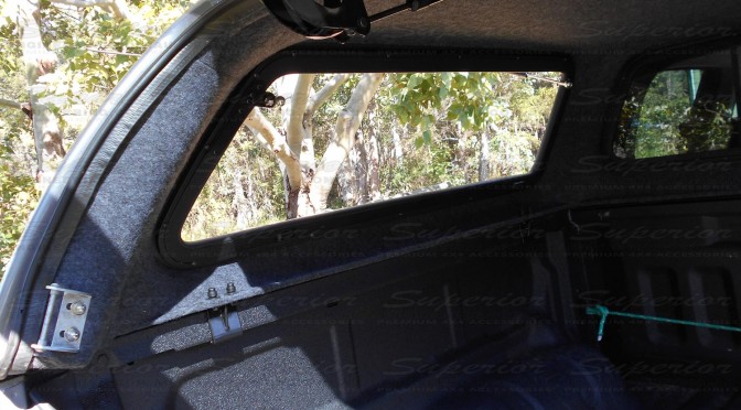 There is an interior gas strut mounted to the rear window to help opening and closing the canopy a breeze